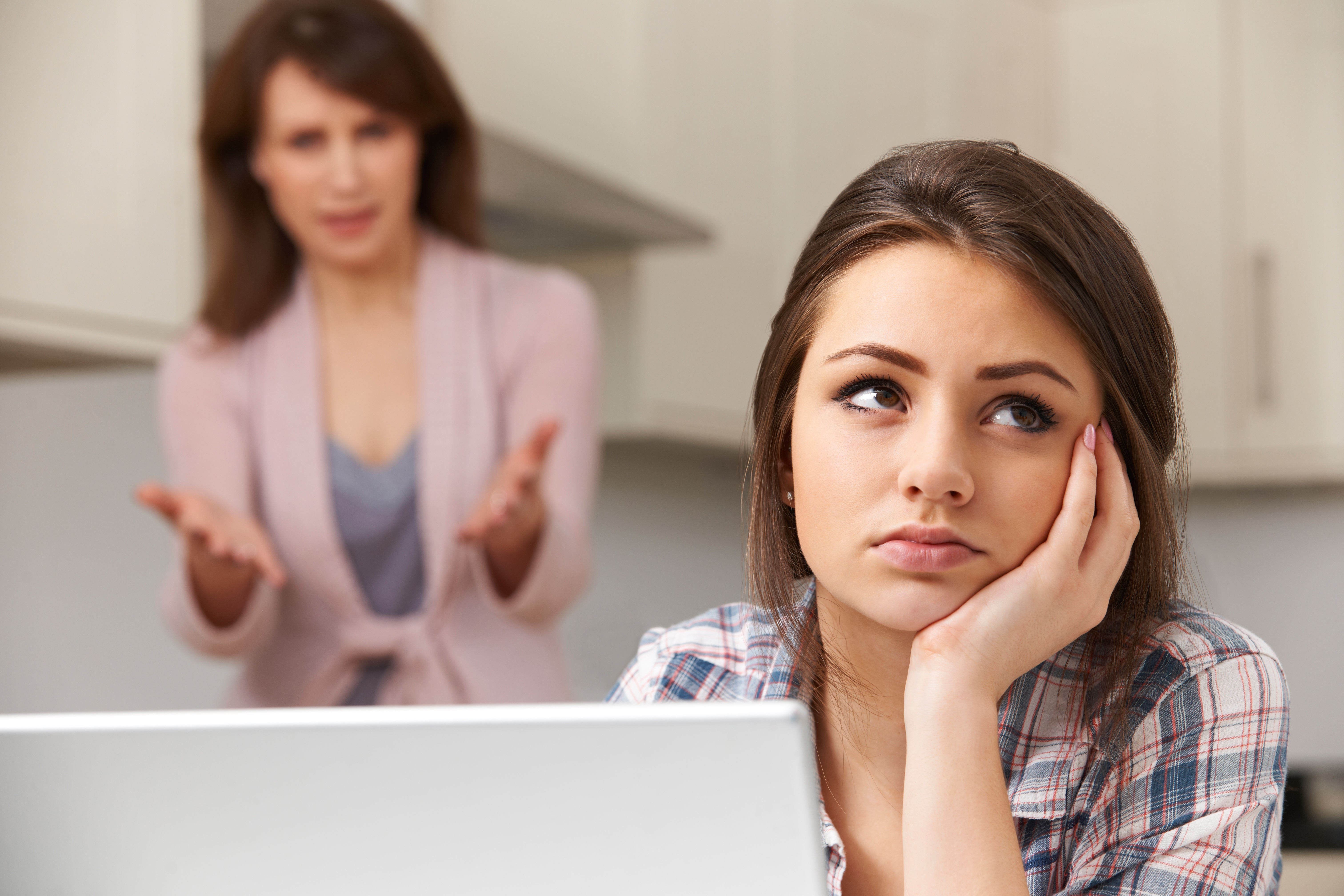 Mother Arguing With Teenage Daughter Over Online Activity
